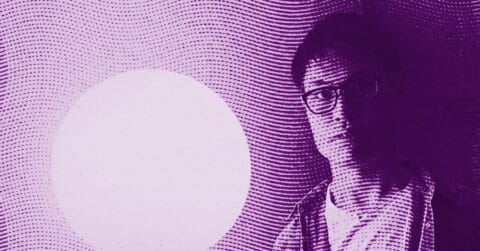 A man wearing glasses stands next to a large, white circular shape. The image is tinted purple and overlaid with wavy, dotted lines, creating a stylized, abstract effect. © Illustration by ArtCritic.