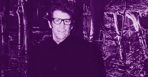 A man wearing glasses stands in front of a background with abstract, textured patterns. The entire image is filtered in shades of purple. © Illustration by ArtCritic.