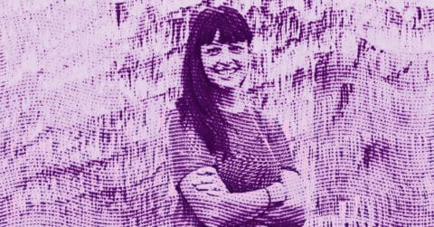 A stylized, purple-tinted image of a person standing with arms crossed and smiling, created with a dotted, wave-like texture effect that distorts the background and figure. © Illustration by ArtCritic.