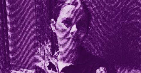 A stylized portrait of a person with short hair, shown in purple tones and overlaid with a pattern of wavy horizontal lines, creating a textured, abstract effect. © Illustration by ArtCritic.