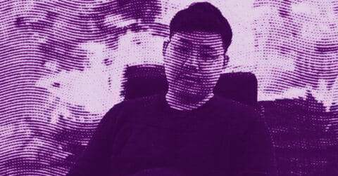 A person sitting in a chair, looking at the camera. The image is stylized with purple tonal effects and wavy textured lines running across the entire scene, giving it an abstract, artistic appearance. © Illustration by ArtCritic.
