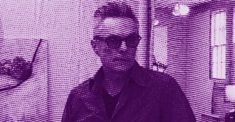 A person wearing glasses and a jacket stands indoors, partially obscured by a purple halftone dot pattern overlay. The background shows a doorway and wall decor. © Illustration by ArtCritic.