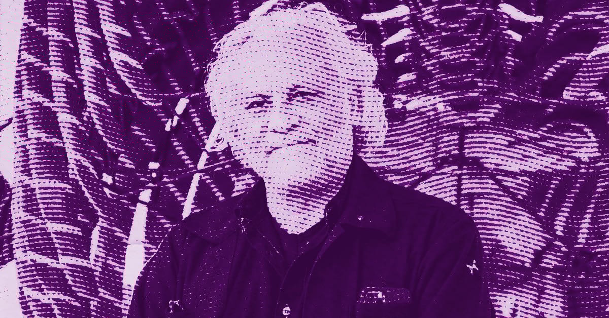 Gabriel Orozco with short, light-colored hair smiles while standing in front of a patterned background. The image is overlaid with a purple filter and a dotted, halftone effect. © Illustration by ArtCritic.