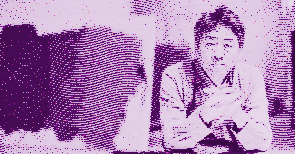 A stylized, purple-toned image of Tan Ping sitting with his hands clasped, looking forward. The image features a wavy, halftone pattern that gives it a textured, abstract appearance. © Illustration by Art Critic.