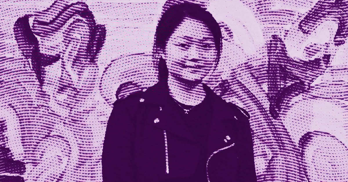 A stylized purple and pink image of Etsu Egami, wearing a jacket, standing in front of a mural with abstract patterns and faces. The image has a dotted, screen-printed texture throughout. © Illustration by Art Critic.