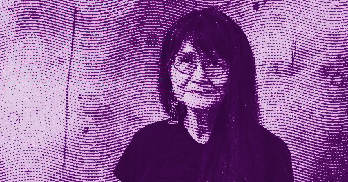 A stylized purple halftone image of Emmi Whitehorse with long hair and glasses, smiling, standing against a textured wall with wavy lines. © Illustration by Art Critic.