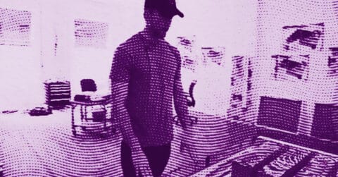 Kelley Walker in a cap stands in a room with shelves and various objects; the image has a purple filter and a wavy, dotted effect that partially obscures details. © Illustration by Art Critic.