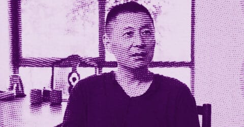 Geng Jianyi sits indoors in front of a window and workshop items, facing slightly to the side. The image has a purple color filter and a halftone dot effect. © Illustration by Art Critic.