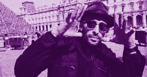 A stylized, purple-toned image of the French artist JR wearing sunglasses and a hat, with hands raised and fingers pointing. In the background, there are large classical buildings. The image has a dotted, halftone pattern effect. © Illustration by Art Critic.