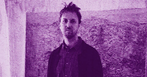 A portrait of the artist Theodore Ereira-Guyer standing against a wall, overlaid with a pattern of horizontal dotted lines. The image is tinted purple, giving it an abstract, artistic look. © Illustration by Art Critic.