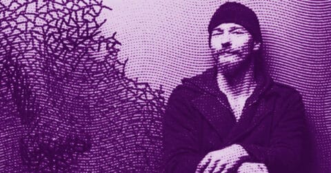 A digitally altered purple-toned image of Nikola Vudrag wearing a beanie and coat, sitting with hands folded, features dotted patterns and abstract shapes filling the background. © Illustration by Art Critic.