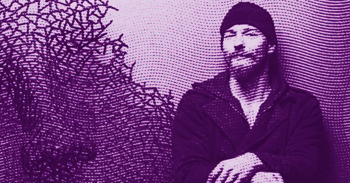 A digitally altered purple-toned image of Nikola Vudrag wearing a beanie and coat, sitting with hands folded, features dotted patterns and abstract shapes filling the background. © Illustration by Art Critic.