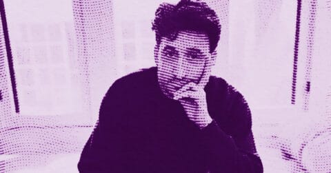 A stylized, purple-tinted image of Calvin Marcus with short dark hair resting his chin on one hand, sitting in front of light curtains. The image features a halftone dot pattern effect. © Illustration by Art Critic.