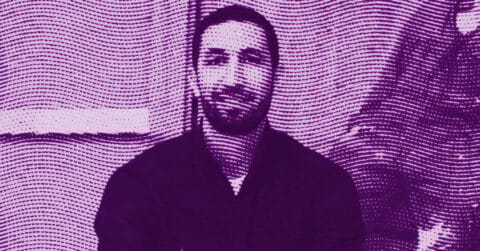 A stylized, purple-toned image of Bilal Hamdad with a beard sitting indoors. The image features wavy, dotted lines overlaying the entire scene, creating a textured and abstract effect. © Illustration by Art Critic.
