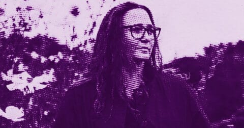 A stylized, purple-toned image of Sharon Lockhart with long hair and glasses standing outdoors, looking to the side, with blurred trees and sky in the background. The image has a halftone pattern effect. © Illustration by Art Critic.
